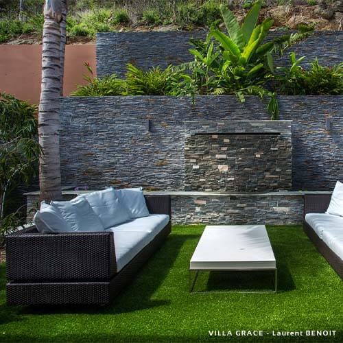 garden terrace with furniture and a wall with natural stone cladding